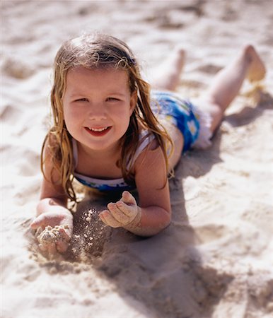 Portrait of Girl in Swimwear Lying in Surf on Beach Stock Photo - Rights-Managed, Code: 700-00081665
