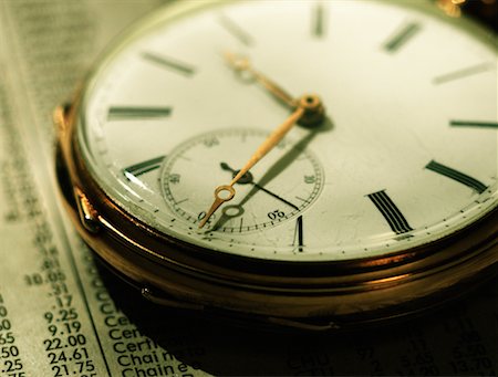 simsearch:600-00061060,k - Close-Up of Pocket Watch on Financial Page Stock Photo - Rights-Managed, Code: 700-00081671