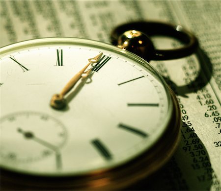 simsearch:600-02886550,k - Close-Up of Pocket Watch on Financial Page Stock Photo - Rights-Managed, Code: 700-00081672