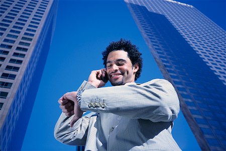 simsearch:700-00027893,k - Businessman Using Cell Phone Checking Watch by Office Towers Los Angeles, California, USA Foto de stock - Con derechos protegidos, Código: 700-00082217