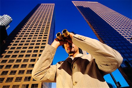 Businessman Using Binoculars by Office Towers Los Angeles, California, USA Stock Photo - Rights-Managed, Code: 700-00082213