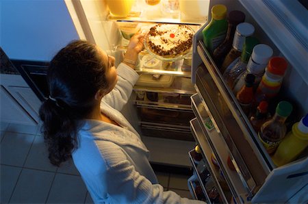 Woman Standing at Fridge, Having Pie as Midnight Snack Stock Photo - Rights-Managed, Code: 700-00082296
