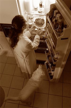 Woman Standing at Fridge, Having Chicken as Midnight Snack Stock Photo - Rights-Managed, Code: 700-00082298