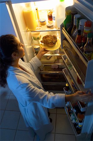 Woman Standing at Fridge, Having Chicken as Midnight Snack Stock Photo - Rights-Managed, Code: 700-00082299