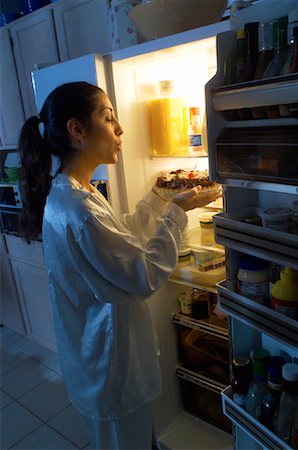 Woman Standing at Fridge, Having Midnight Snack of Pie Stock Photo - Rights-Managed, Code: 700-00082291