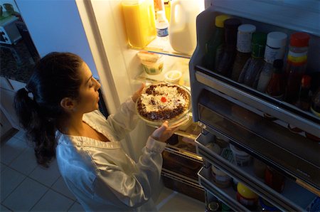 Woman Standing at Fridge, Having Midnight Snack of Pie Stock Photo - Rights-Managed, Code: 700-00082292