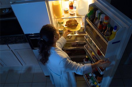 Woman Standing at Fridge, Having Chicken as Midnight Snack Stock Photo - Rights-Managed, Code: 700-00082300