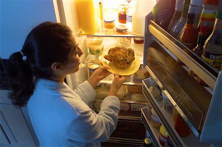 Woman Standing at Fridge, Having Chicken as Midnight Snack Stock Photo - Rights-Managed, Code: 700-00082301