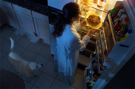 dogs and woman in kitchen - Woman Standing at Fridge, Having Chicken as Midnight Snack Stock Photo - Rights-Managed, Code: 700-00082302