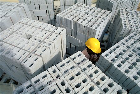 Construction Worker and Cement Blocks Singapore Fotografie stock - Rights-Managed, Codice: 700-00082499