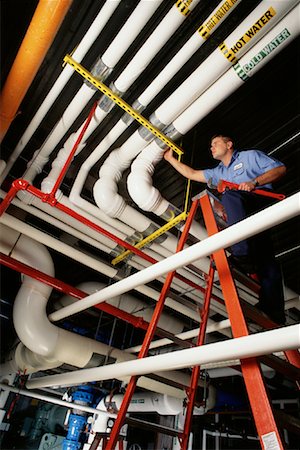 factory workers piping - Man Installing Pipes in Factory Stock Photo - Rights-Managed, Code: 700-00082985