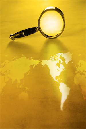 World Map with Magnifying Glass Standing on Edge Stock Photo - Rights-Managed, Code: 700-00083038