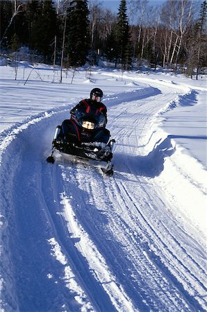 people on snowmobiles - Person Riding Snowmobile on Trail Laurentian Region, Quebec, Canada Stock Photo - Rights-Managed, Code: 700-00083855