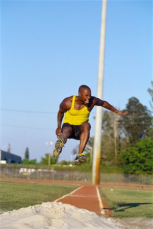 salto em distância - Running Long Jump Foto de stock - Direito Controlado, Número: 700-00095533