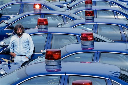 Man Leaning Against Police Car Stock Photo - Rights-Managed, Code: 700-00095798