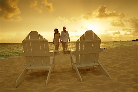 Couple on Beach Walking Toward Adirondack Chairs Paradise Island, Bahamas Stock Photo - Rights-Managed, Code: 700-00096381