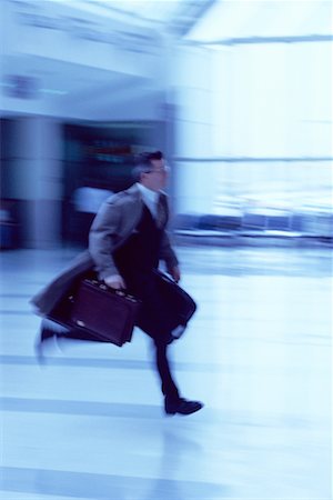 Businessman Running Through Airport Stock Photo - Rights-Managed, Code: 700-00096515