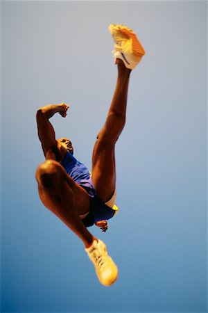 salto in lungo - Man Jumping in Track and Field Event Fotografie stock - Rights-Managed, Codice: 700-00098173