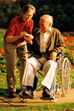 Femme mûre avec un homme mûr en fauteuil roulant Photographie de stock - Rights-Managed, Code: 700-00099916