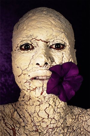 Person With Cracked Coating on Skin With Flower in Mouth Stock Photo - Rights-Managed, Code: 700-00090128