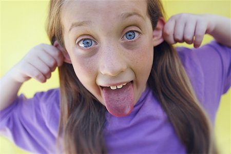 preteen girls tongue - Portrait of Girl Making Face Stock Photo - Rights-Managed, Code: 700-00090779
