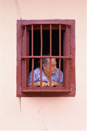 Woman Looking Through Barred Window Stock Photo - Rights-Managed, Code: 700-00092096