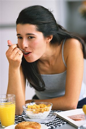 Woman Eating Breakfast Foto de stock - Con derechos protegidos, Código: 700-00092592