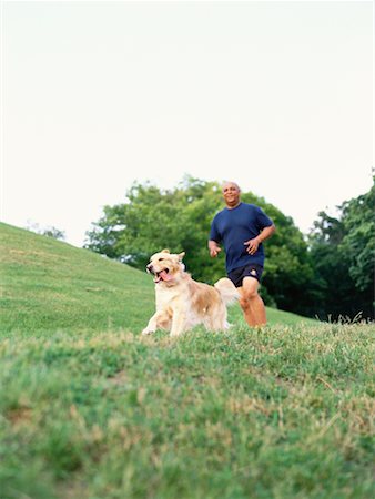 Man Running With Golden Retriever Stock Photo - Rights-Managed, Code: 700-00092634