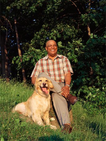 Man Sitting With Golden Retriever Fotografie stock - Rights-Managed, Codice: 700-00092638