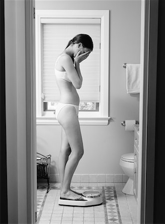 Woman Weighing Herself Stock Photo - Rights-Managed, Code: 700-00092733