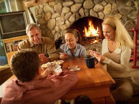 people adult fireplace fun - Family Playing Cards Stock Photo - Rights-Managed, Code: 700-00093239