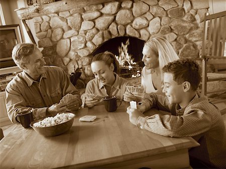 people adult fireplace fun - Family Playing Cards Stock Photo - Rights-Managed, Code: 700-00093240