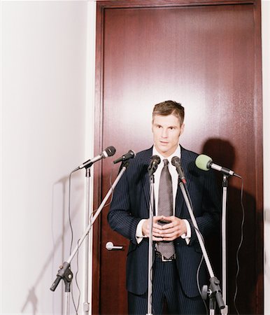 Businessman at Microphones Foto de stock - Con derechos protegidos, Código: 700-00093319