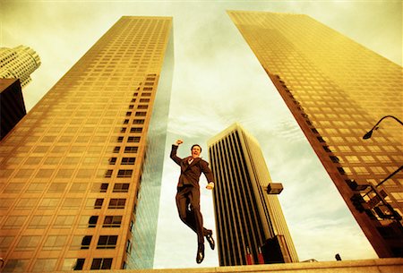 skyscraper company suit - Businessman Jumping in the Air Foto de stock - Con derechos protegidos, Código: 700-00093461