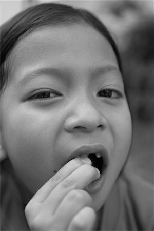 Girl with Loose Tooth Stock Photo - Rights-Managed, Code: 700-00155966