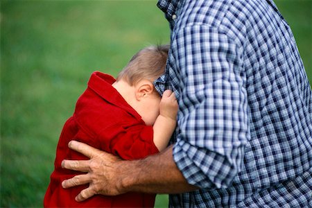 father and son hugging crying