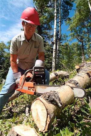 safety gear for logging and forestry - Woman Working with Chainsaw Stock Photo - Rights-Managed, Code: 700-00158241