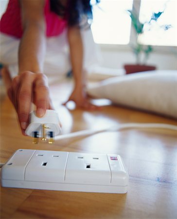 electrical plugs inside socket - Plug Going into Outlet Stock Photo - Rights-Managed, Code: 700-00158284