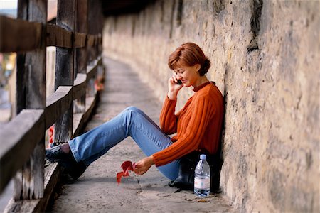 Woman Sitting Outdoors with Cellular Phone Stock Photo - Rights-Managed, Code: 700-00158486