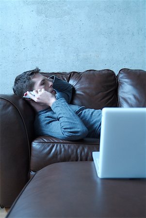 simsearch:700-00159009,k - Man Lying on Couch Talking on Phone Stock Photo - Rights-Managed, Code: 700-00159009