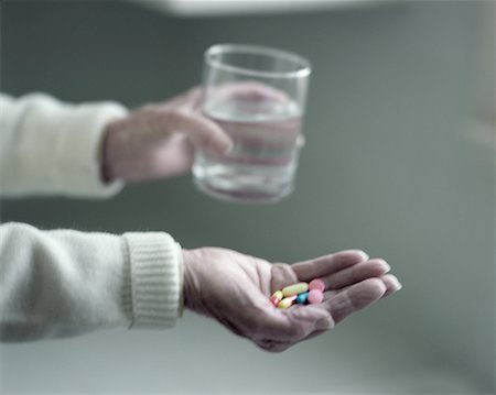 Elderly Women Holding Pills Stock Photo - Rights-Managed, Code: 700-00159100