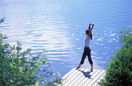 secluded lake woman - Woman Stretching on Dock Stock Photo - Rights-Managed, Code: 700-00159878