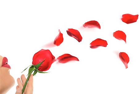 Woman Blowing Rose Petals Into Air Stock Photo - Rights-Managed, Code: 700-00150485