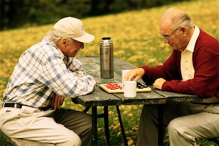 Two Mature Men Playing Checkers Outdoors Stock Photo - Rights-Managed, Code: 700-00150672