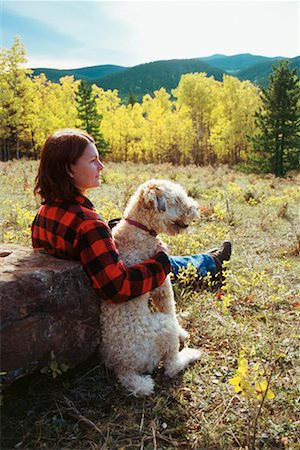 soft coated wheaten terrier - Woman and Dog Sitting in Field Stock Photo - Rights-Managed, Code: 700-00150854