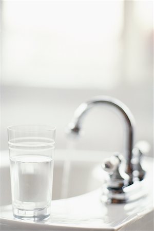 pictures of water glass and faucet - Glass Of Water On Bathroom Sink Stock Photo - Rights-Managed, Code: 700-00151418