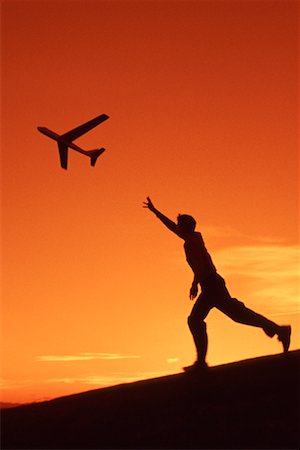 plane silhouette side - Boy Flying Toy Airplane Stock Photo - Rights-Managed, Code: 700-00151584