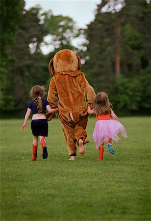 Person in Bear Costume Walking With Two Girls Stock Photo - Rights-Managed, Code: 700-00151936