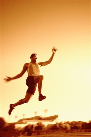 salto in lungo - Man Long Jumping Fotografie stock - Rights-Managed, Codice: 700-00153526