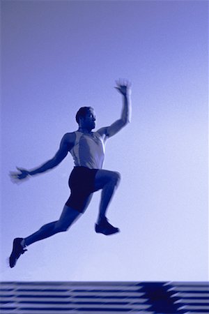 salto em distância - Man Long Jumping Foto de stock - Direito Controlado, Número: 700-00153528